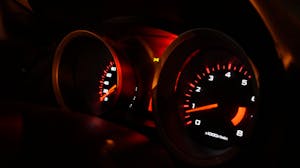 A detailed view of illuminated car gauges on the dashboard at night in the category automotive at brevard business guide